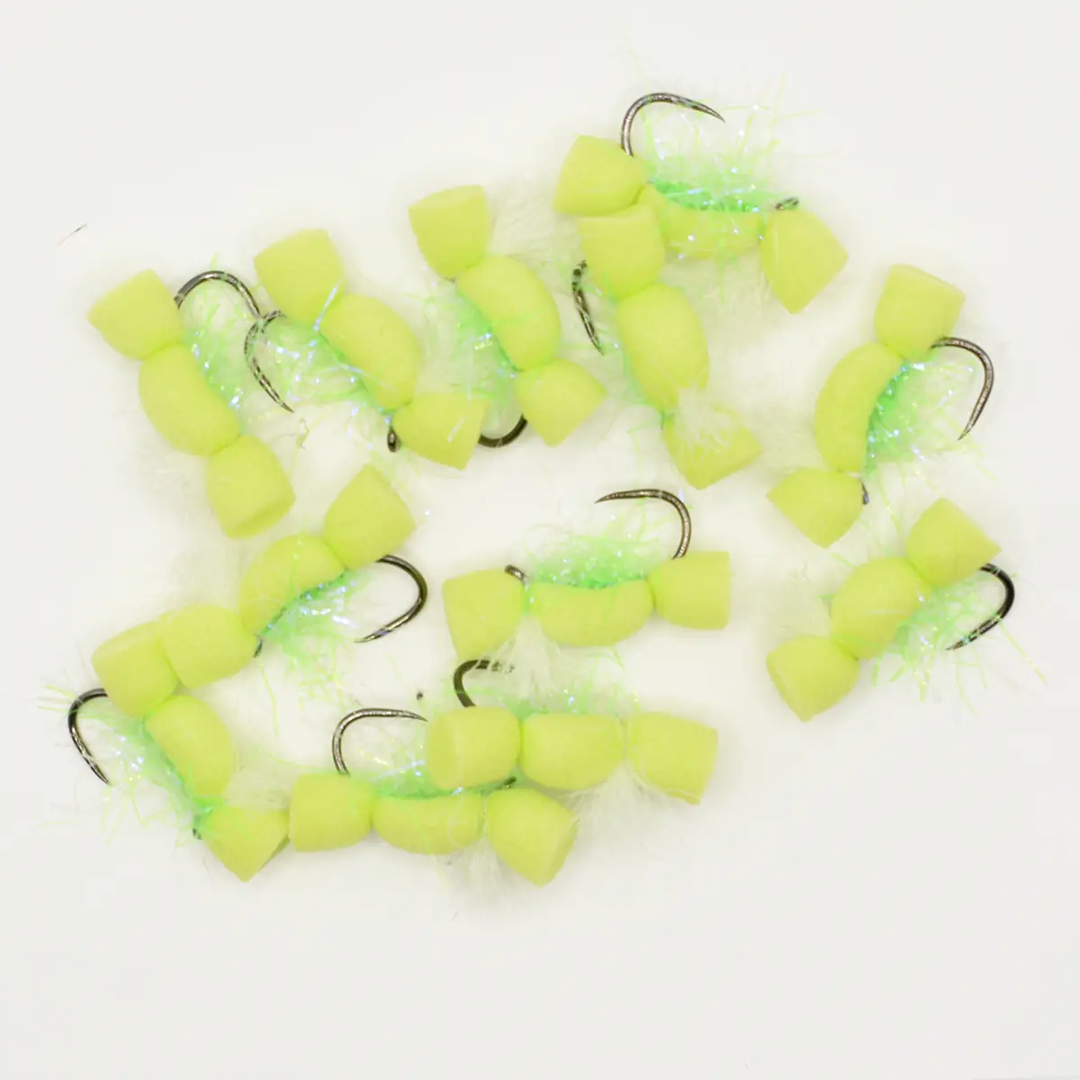 Group of neon yellow foam fishing flies with hooks and green thread on a white background.