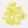 Pile of yellow foam fishing flies with white feather accents and metal hooks