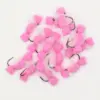 Pile of pink fuzzy pom-pom fishing lures with metal hooks