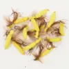 Assorted bright yellow soft plastic fishing lures with brown feather tails and hooks laid on a white background in a tangled cluster