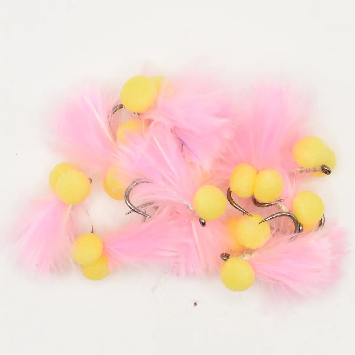 Pink feathered fishing flies with yellow foam bead heads and hooks, arranged in a cluster (fly fishing lures).