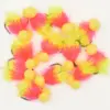 Assortment of neon pink and yellow fluffy fishing lures with yellow foam beads on hooks