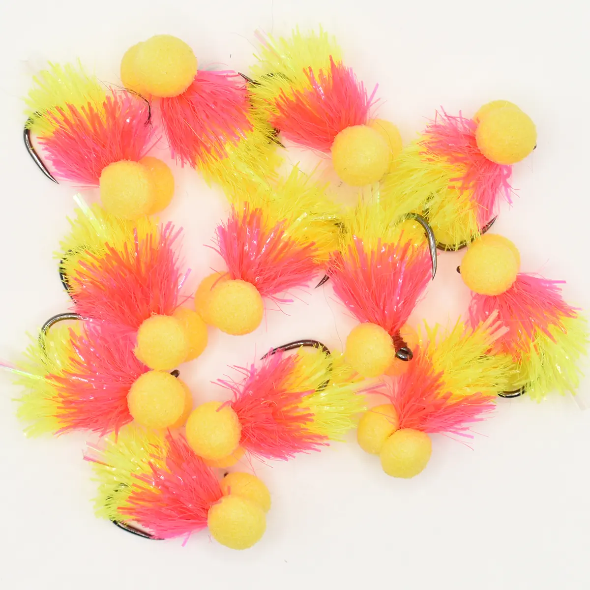 Assortment of neon pink and yellow fluffy fishing lures with yellow foam beads on hooks