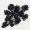 Cluster of black fuzzy fishing lures with purple iridescent tinsel and red beads on hooks