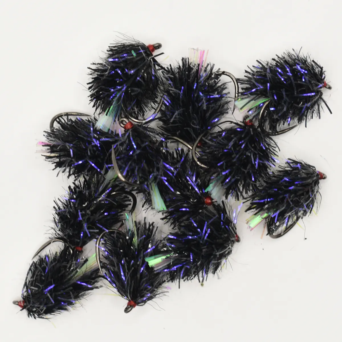 Cluster of black fuzzy fishing lures with purple iridescent tinsel and red beads on hooks