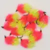 Assortment of neon pink and yellow fluffy fishing lures with metal hooks on a white background.