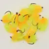 Pile of bright yellow and orange fluffy fishing flies with hooks on a white surface.
