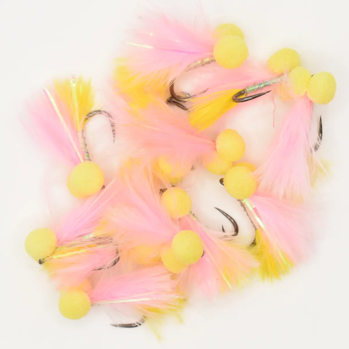 Pastel pink and yellow feather garland with yellow fluffy pom-poms on a white background, a decorative prop.
