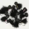 Assortment of black feather fishing lures with fuzzy pom-pom beads and sharp hooks.