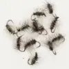 Assorted dark, fluffy fishing flies with long hackle and sharp hooks laid on a white surface.