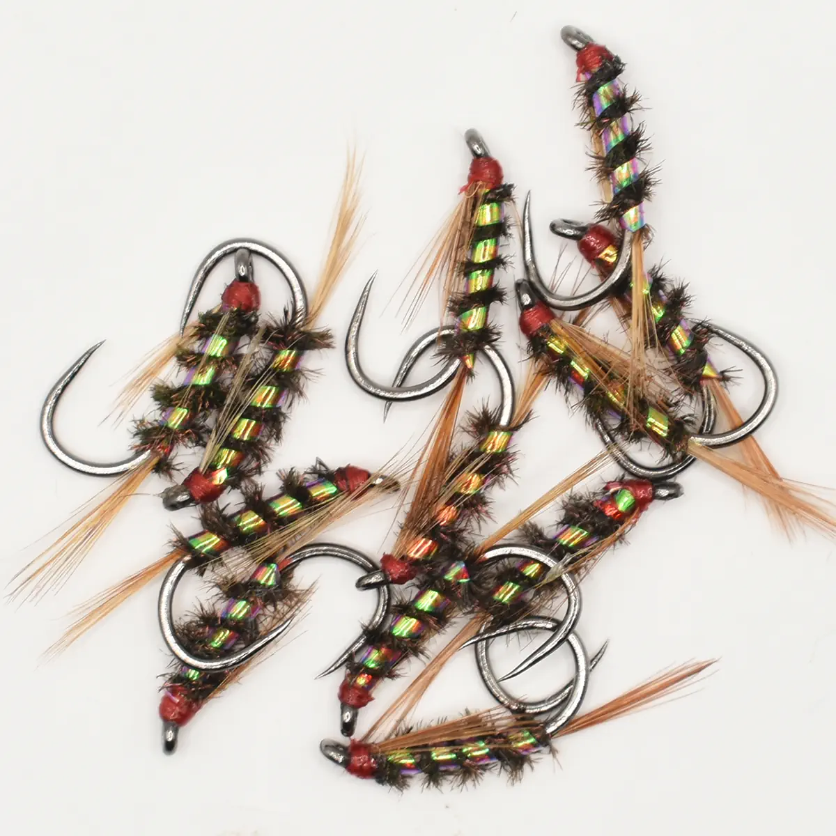 Assortment of colorful fishing lures with iridescent bodies, red heads, and feathered tails on a white background.
