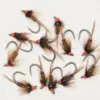 Assorted fishing flies with brown feather tails and orange-thread heads arranged on a white background.