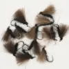 Assorted brown and black woolly bugger fishing flies with metal hooks, used for fly fishing