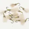 Assorted fly fishing lures with green striped bodies and fluffy tan tails scattered on a white background