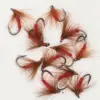 Assorted red hackle fishing flies with brown feather tails on a white background