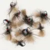 Assortment of fly fishing lures with tan and black fur on hooks, blue thread accents.