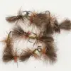Assorted fluffy brown fishing flies with fur tails and green ribbed bodies on a white background, arranged for fly fishing.