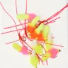 Assorted bright fishing lures with fuzzy feathers in pink, yellow, and orange on red cords and hooks on a white background