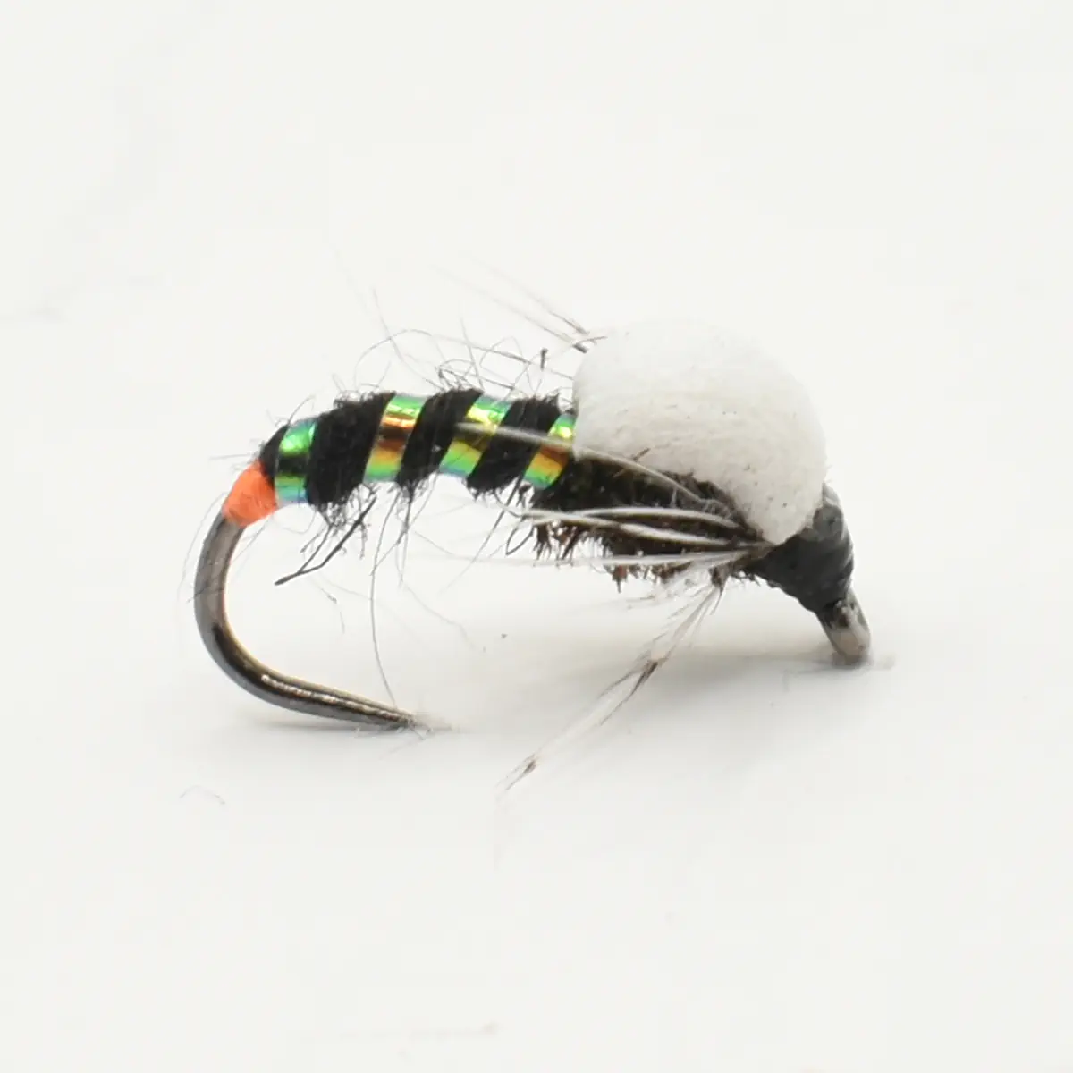 Close-up of a colorful fishing fly with iridescent green stripes and orange head for fly fishing showpiece.