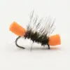 Close-up of a black, fuzzy fishing fly with orange foam posts on a curved hook, used for trout fishing.