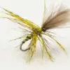 Close-up of a yellow-brown fishing fly (artificial lure) with feather tail and a hooked metal barb, used in fly fishing